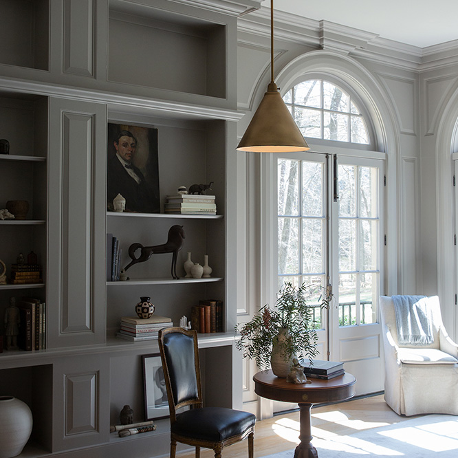 A pendant light over a small table in a living area