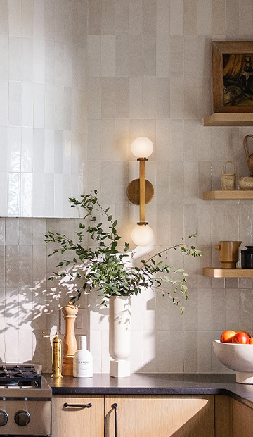 Gold sconce lighting fixture in a kitchen