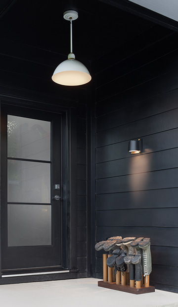 An outdoor pendant light and sconce by entrance