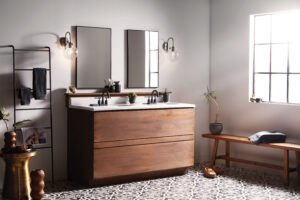 Elegant bathroom featuring Franklin Lighting fixtures. A modern vanity mirror is illuminated by sleek, brushed nickel sconces, casting a warm, soft glow across the marble countertop and chic decor. The perfect blend of style and functionality, highlighting Franklin Lighting's commitment to luxury and design