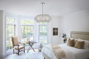 Franklin Lighting Light and airy chandelier with clear glass shades in a bright entryway, replacing a heavier traditional fixture – part of a spring home lighting refresh.