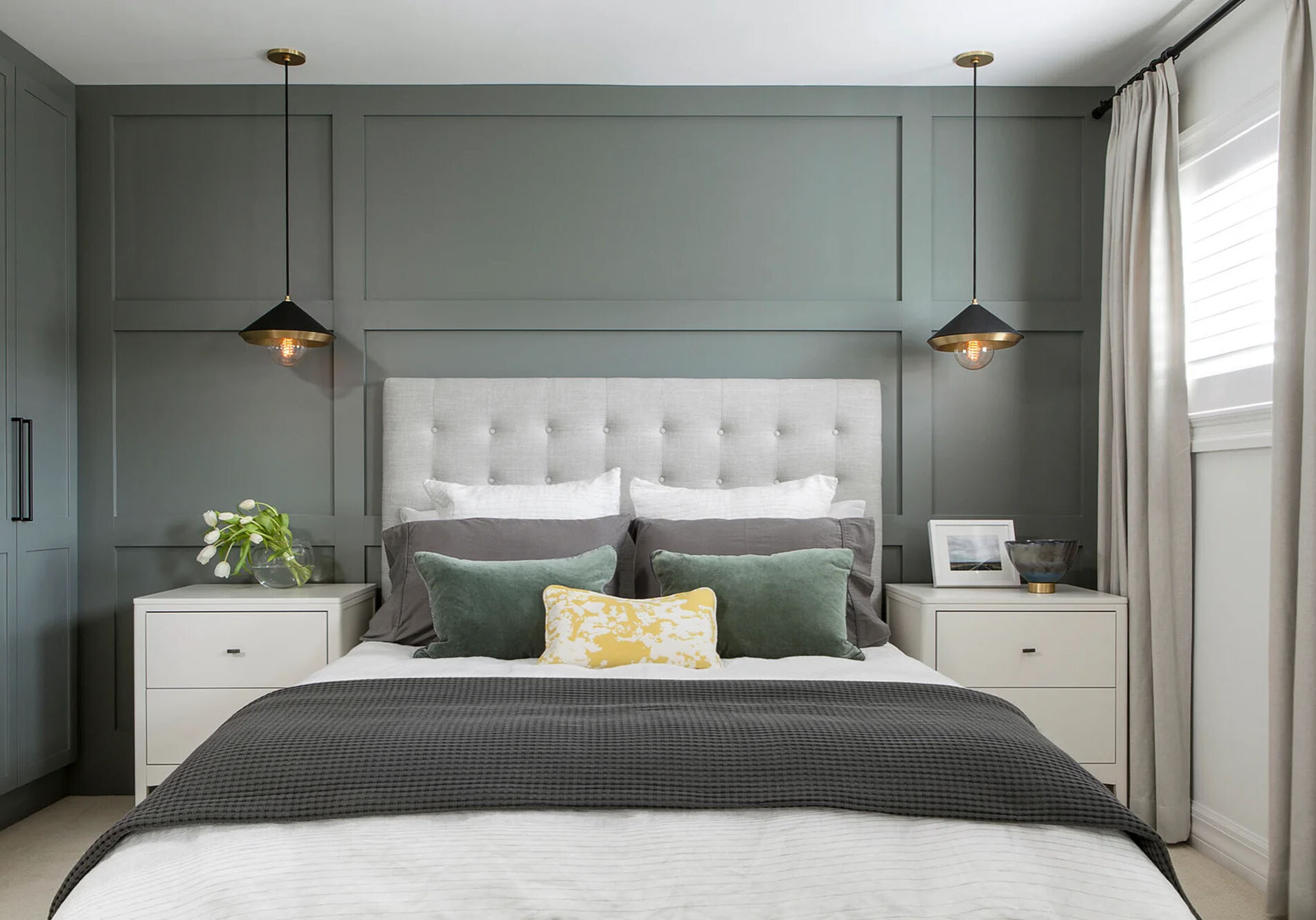 Modern bedroom design with custom made black pendant lighting over nightstands.