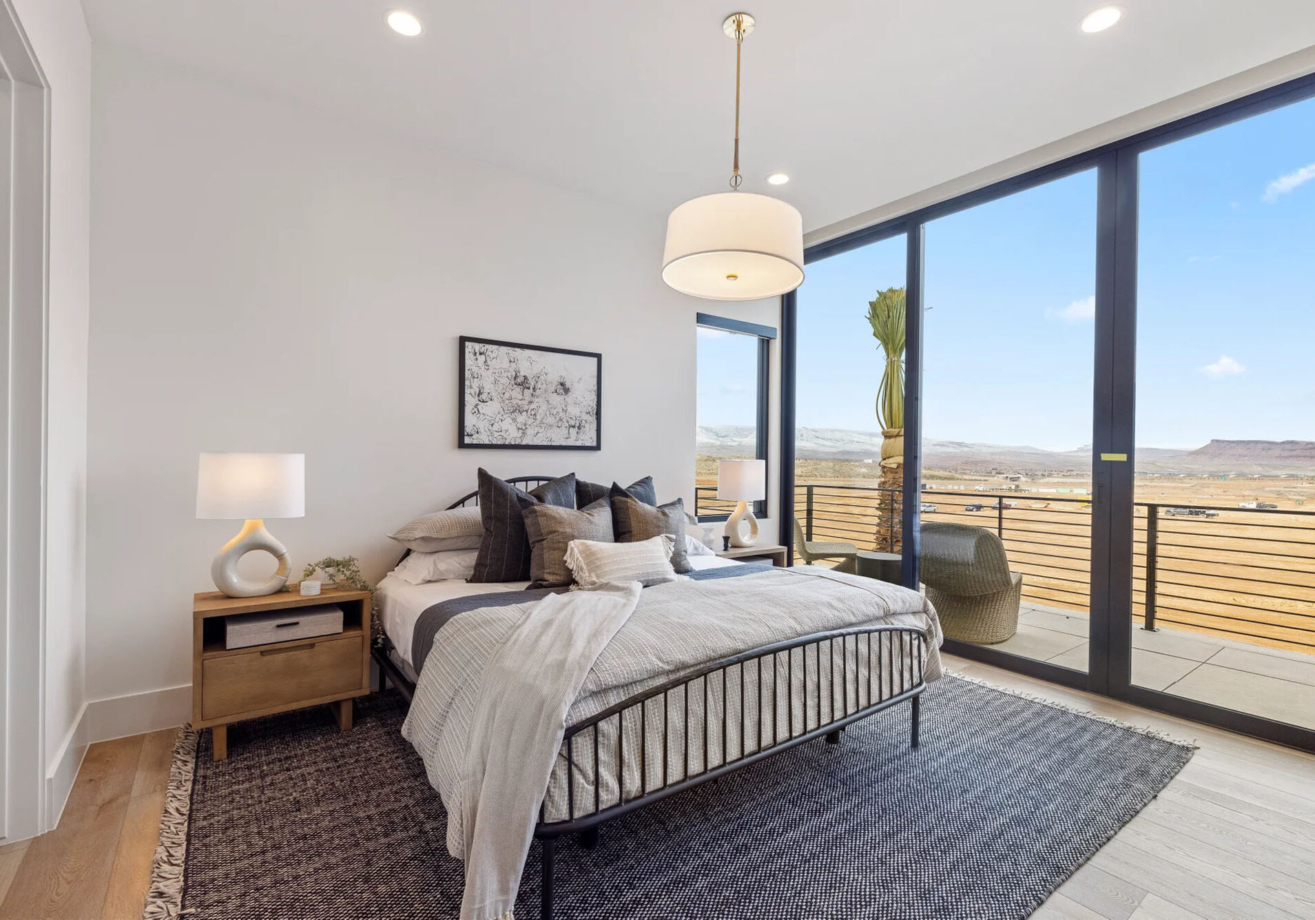 Custom made white pendant light in a luxury bedroom with floor-to-ceiling windows.